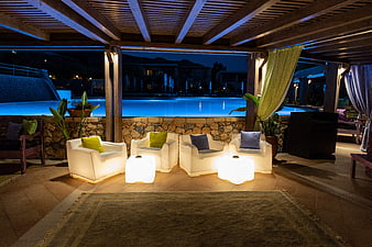 Luxury Resort Poolside Lounge With Illuminated Armchairs At Night