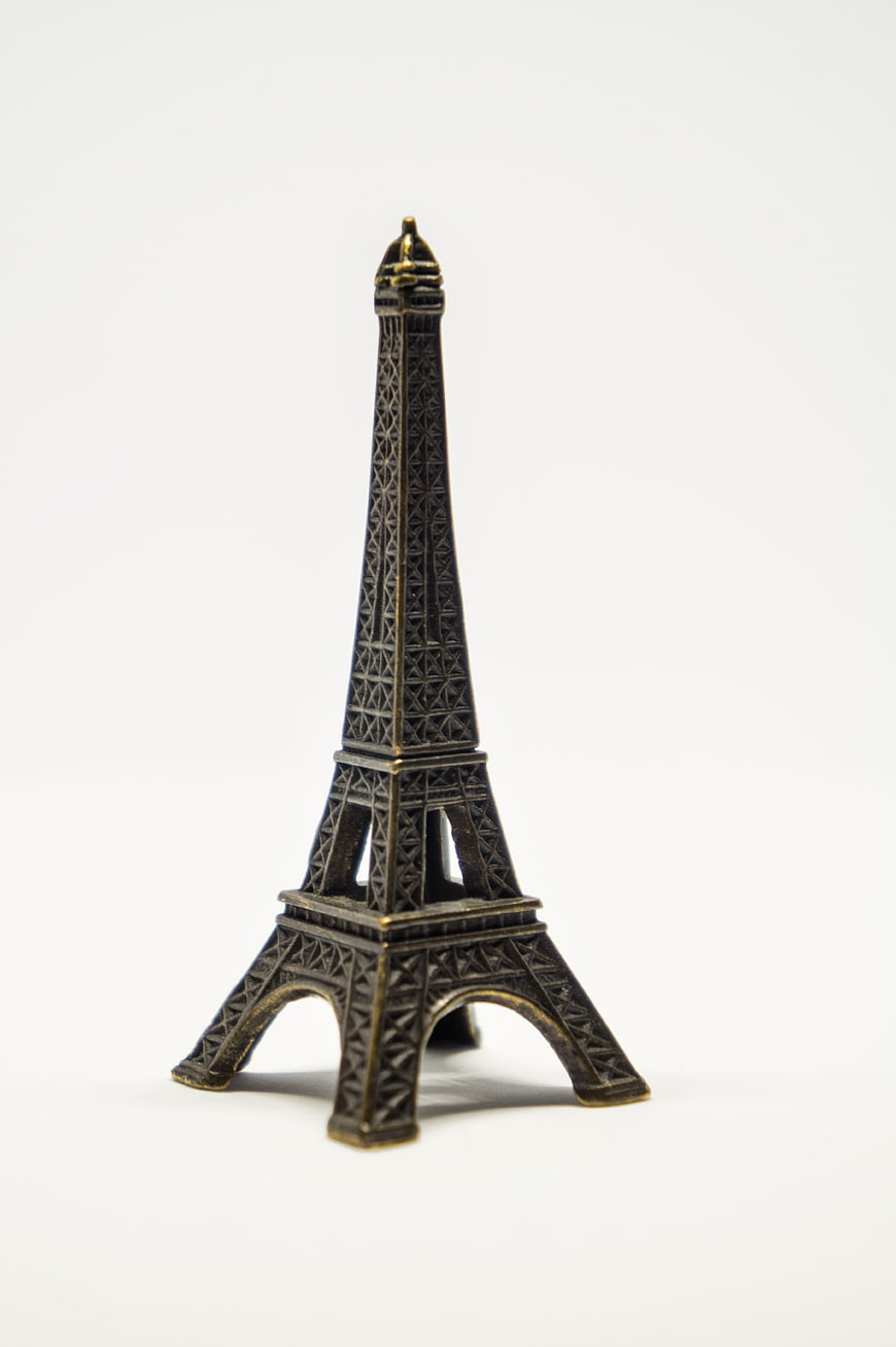 Small Brass Eiffel Tower Souvenir on White Background