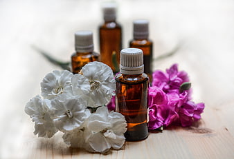 Essential Oil Bottles with White and Pink Carnations