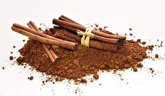 Cinnamon sticks and ground powder on white background