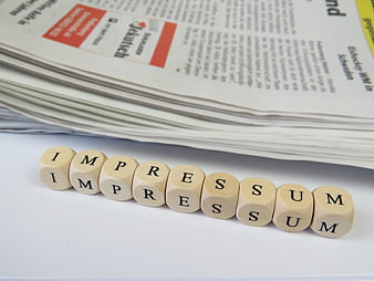Wooden Scrabble Tiles Spelling Imprimatur On White Surface Near Newspaper