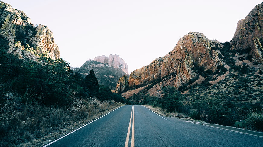 Asphalt road winding through rocky mountain landscape