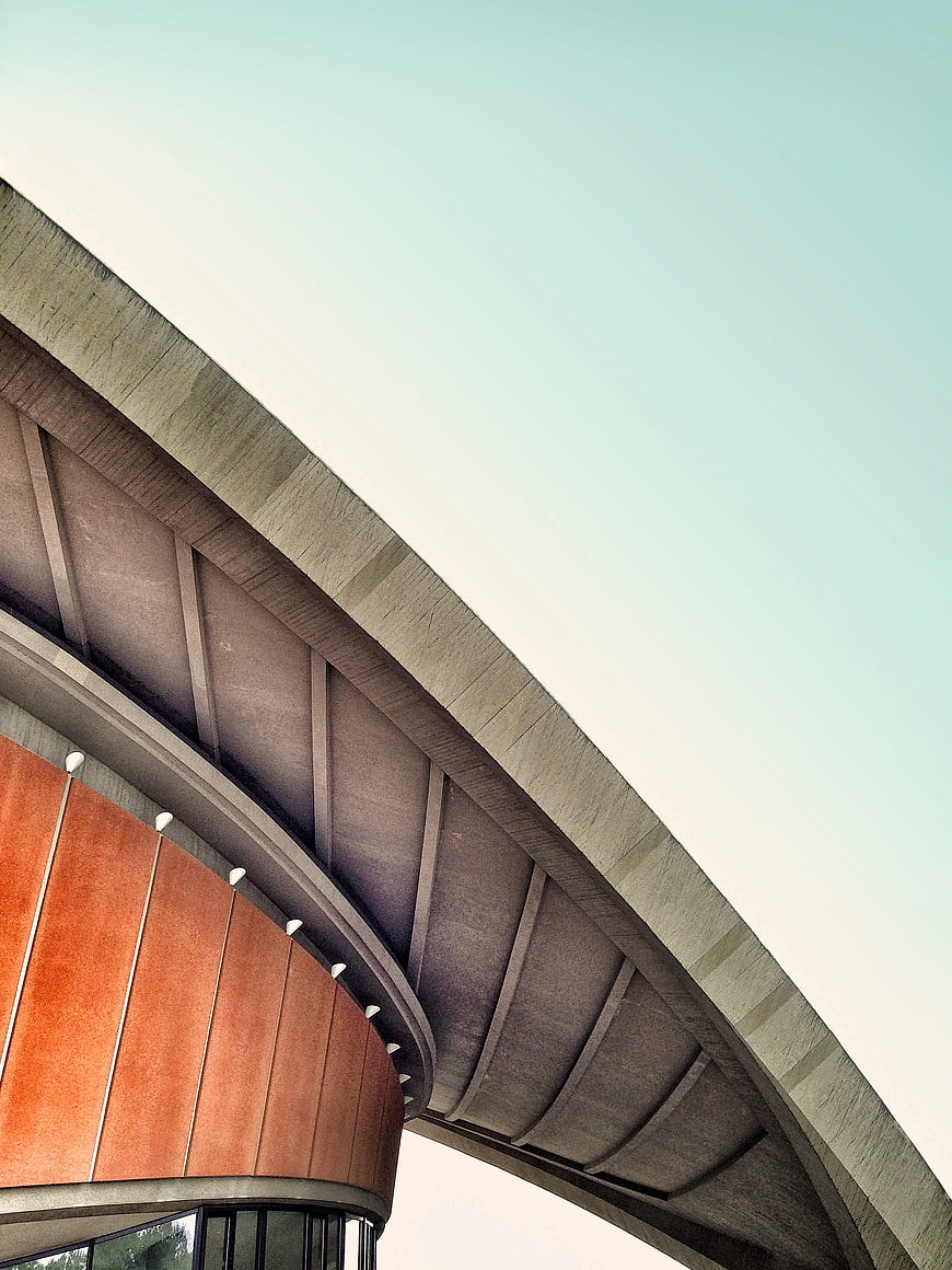 Modern curved concrete bridge architecture against blue sky