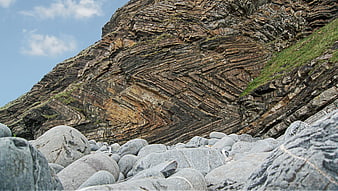 Folded Sedimentary Rock Strata on a Rugged Coastal Cliff