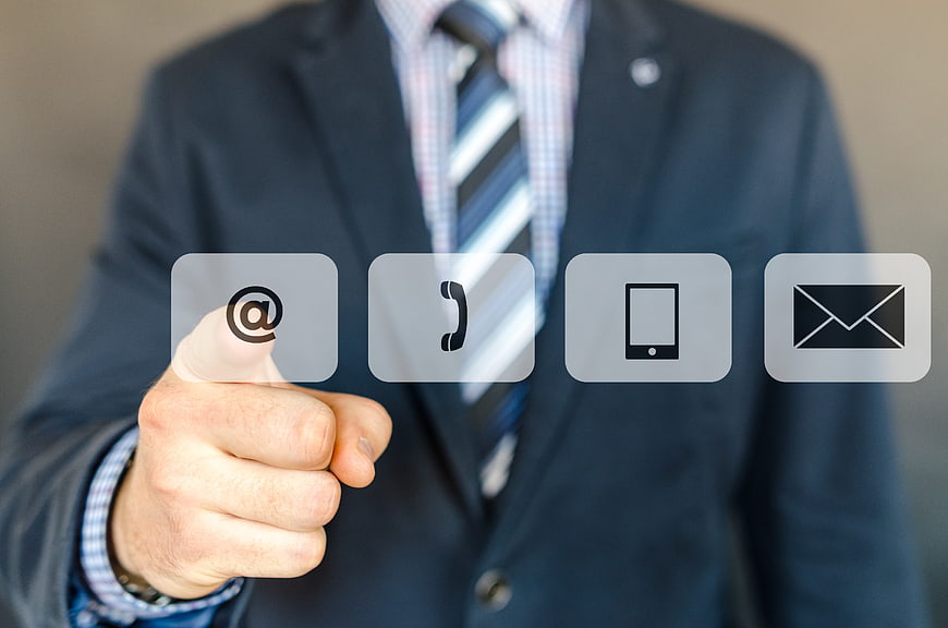 Businessman touching digital contact icons on screen