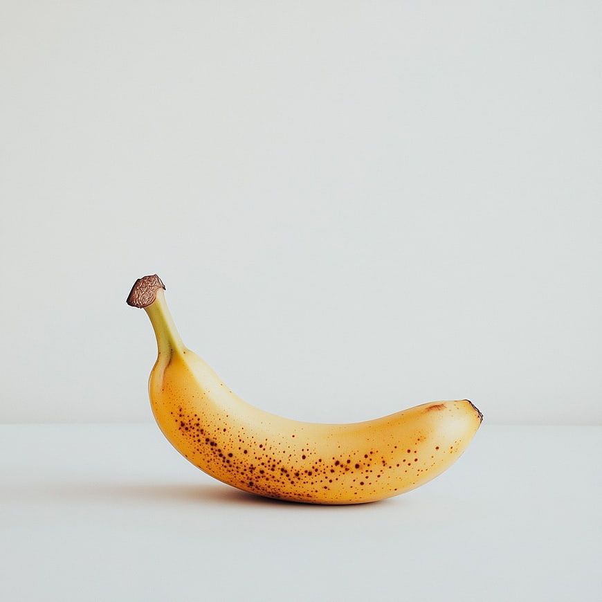 Ripe Spotted Banana on Minimal White Background