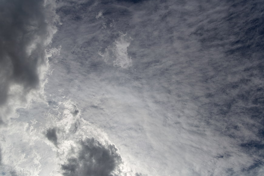 Dramatic moody cloudscape with textured grey and white clouds