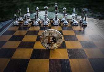 Bitcoin coin on chessboard with silver pieces