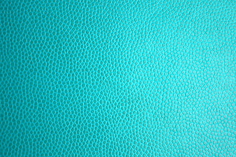 Close-up of textured turquoise leather surface background