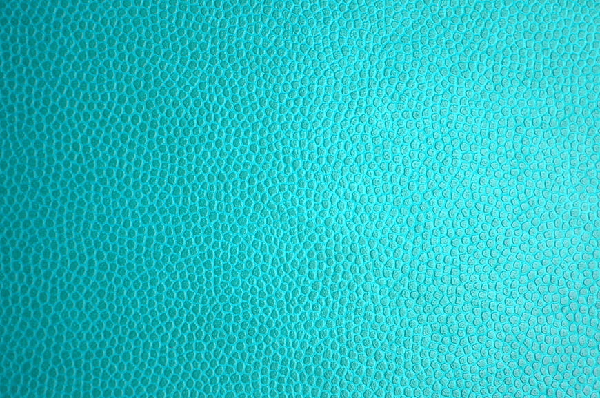 Close-up of textured turquoise leather surface background