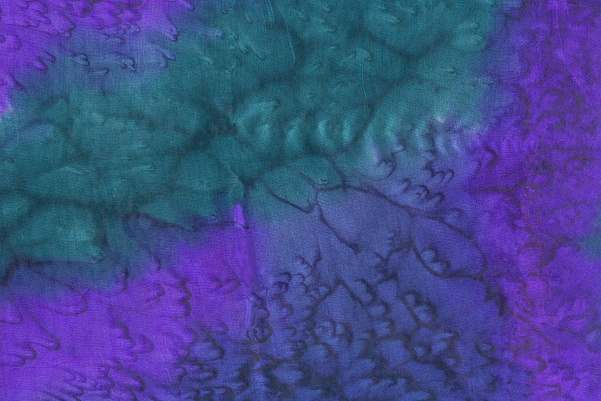 Abstract purple and teal tie-dye silk fabric texture