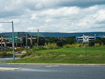 Highway Intersection with Road Signs and Distant Mountains