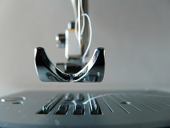 Close-Up of Sewing Machine Presser Foot and Thread