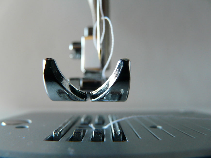 Close-Up of Sewing Machine Presser Foot and Thread