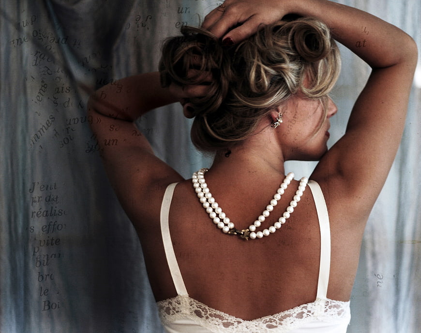 Woman with Pearl Necklace and Vintage Updo Hairstyle