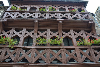 Historic Half-Timbered House Facade With Red Flowers