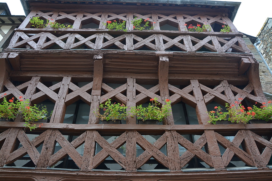 Historic Half-Timbered House Facade With Red Flowers