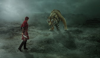 Fantasy warrior woman facing a menacing tiger in a dark, misty landscape