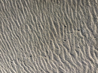 Close-up of rippled sand texture pattern on a beach