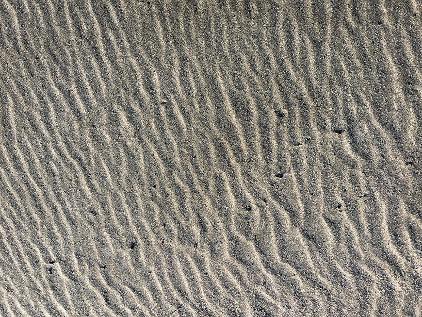 Close-up of rippled sand texture pattern on a beach