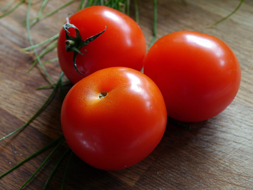 Fresh Red Tomatoes on Wooden Cutting Board