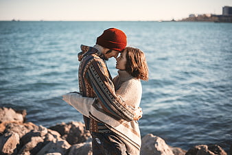 Romantic Couple Hugging by the Sea in Winter
