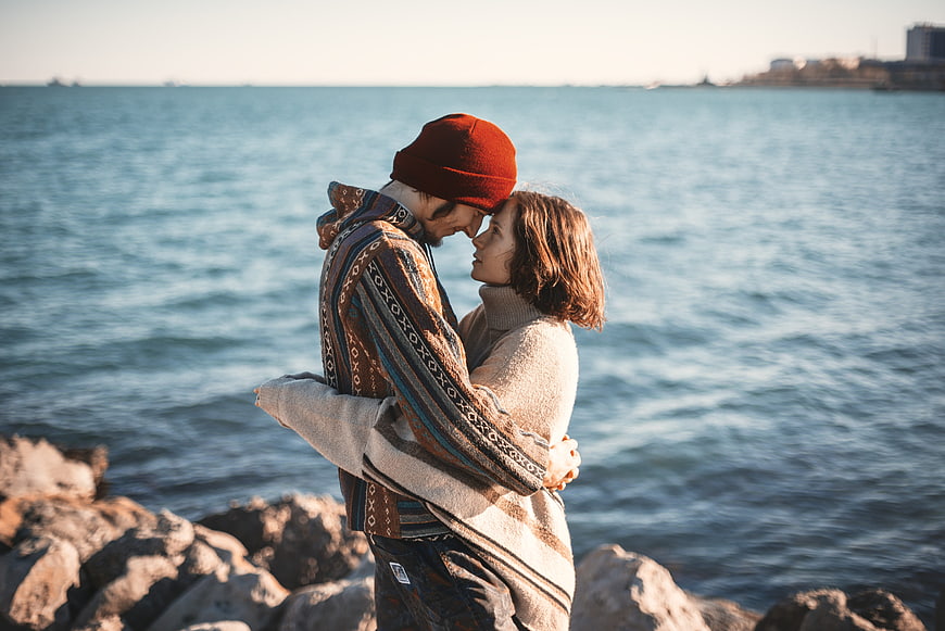 Romantic Couple Hugging by the Sea in Winter