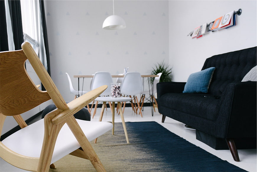 Modern Scandinavian Living Room with Wooden Chair and Black Sofa