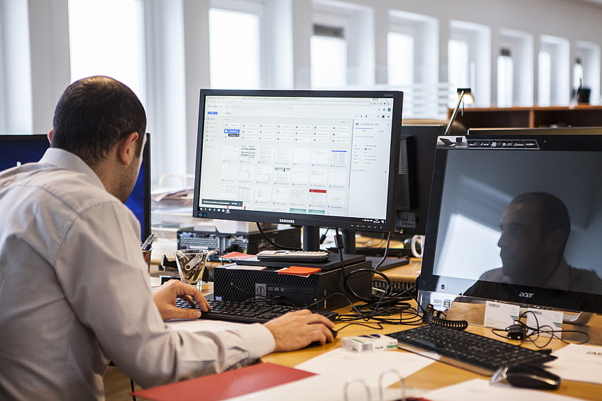 Man working at computer in modern office workspace