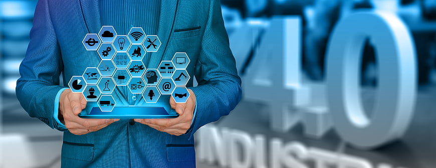 Businessman holding tablet with Industry 4.0 technology icons