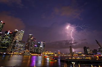 Dramatic Lightning Strike Over Singapore City Skyline at Night