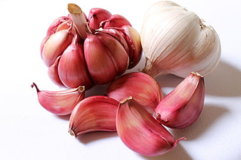 Fresh Red and White Garlic Bulbs and Cloves on White