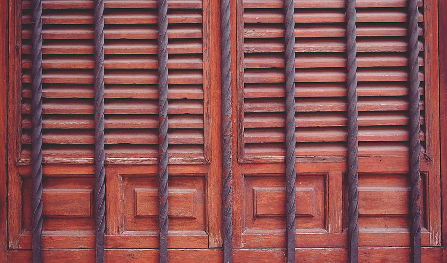 Vintage Wooden Door with Twisted Iron Bars