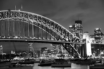 Black and white night view of Sydney Harbour Bridge and city skyline