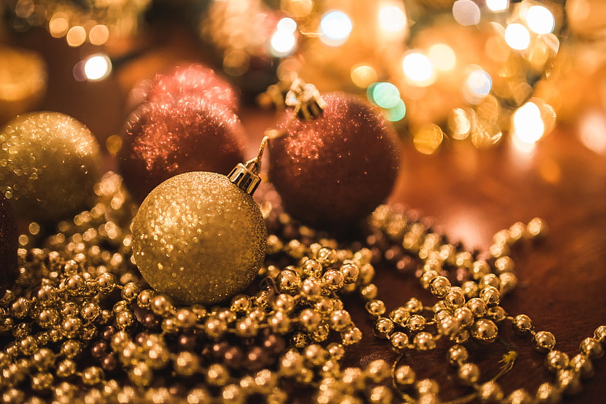 Glittering Gold and Red Christmas Ornaments with Bokeh Lights