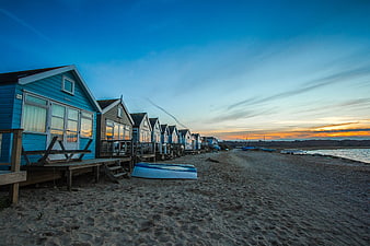 Colorful Beach Huts at Sunset on Sandy Shore