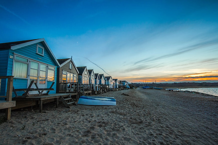 Colorful Beach Huts at Sunset on Sandy Shore