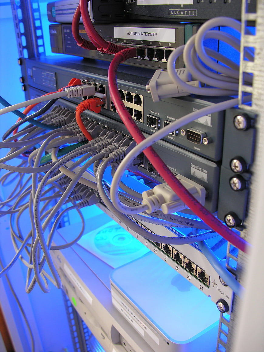 Close-up of server rack with network cables and blue LED lighting