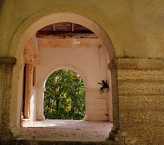 Stone Archway Framing Green Forest View In Italian Architecture