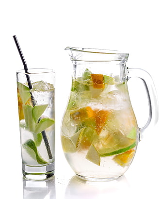Fresh fruit infused water in glass pitcher and tall glass with ice