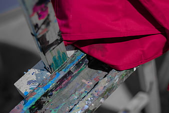 Close-up of Paint-Splattered Wooden Easel with Magenta Cloth