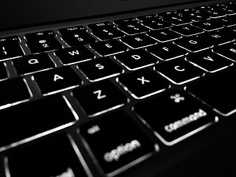 Close-up of illuminated laptop keyboard keys in black and white