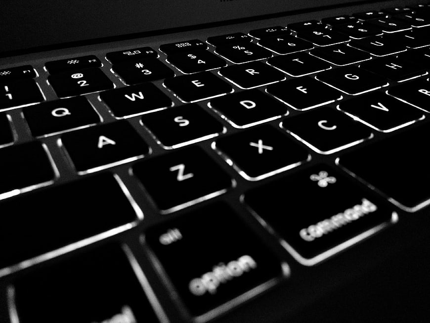Close-up of illuminated laptop keyboard keys in black and white