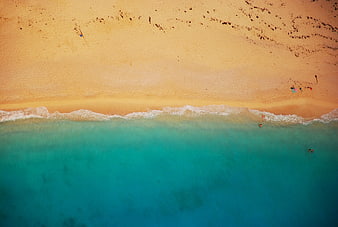 Aerial View of Turquoise Ocean Waves Meeting Sandy Beach