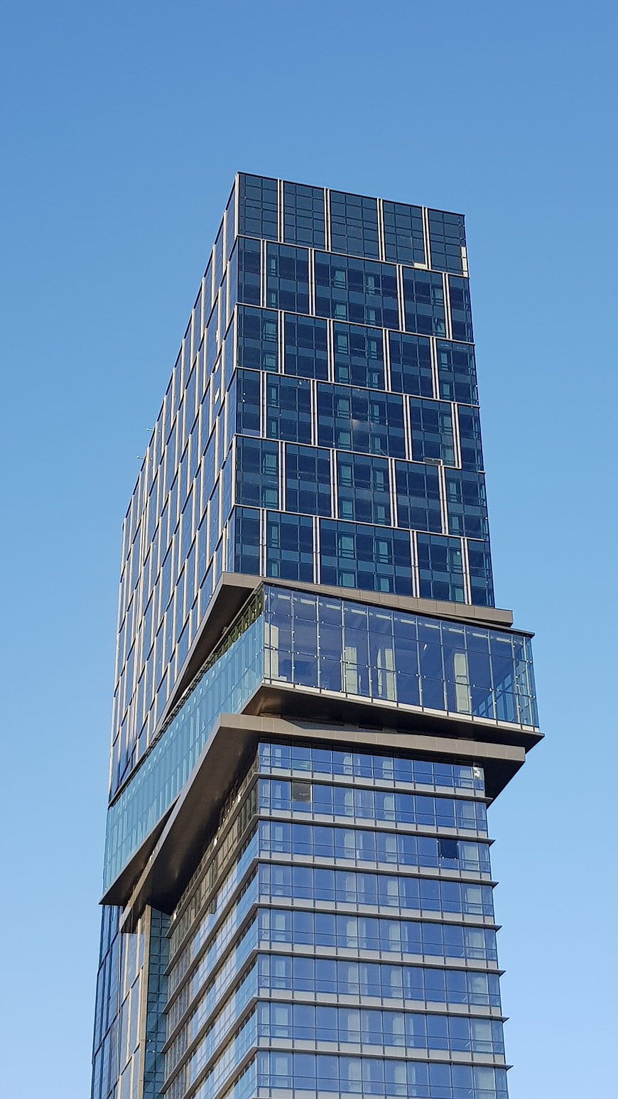 Modern Glass Skyscraper with Cantilevered Section