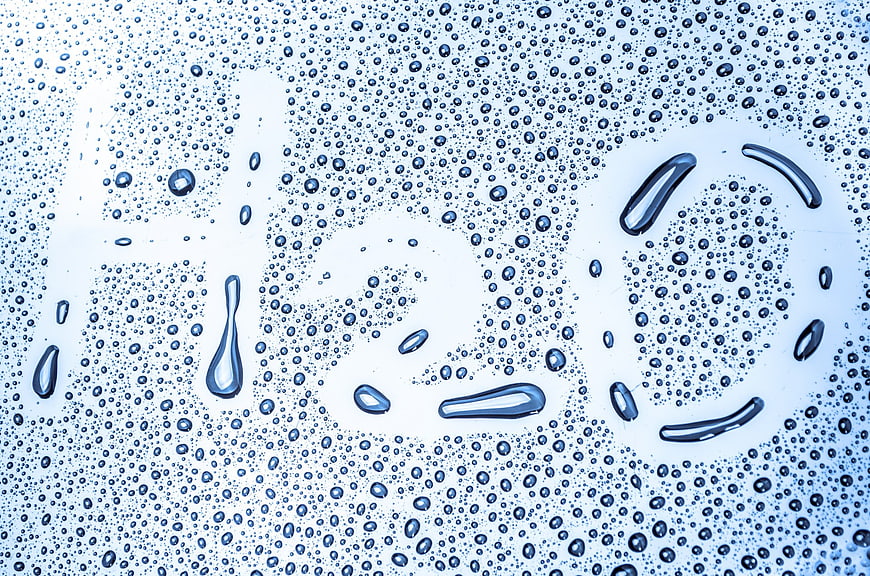 Water droplets on glass forming a smiley face