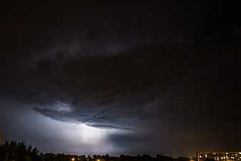 Dramatic Night Lightning Storm Over City Skyline