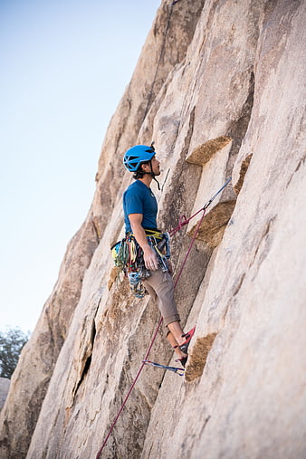 Male Rock Climber Scaling Granite Cliff Face