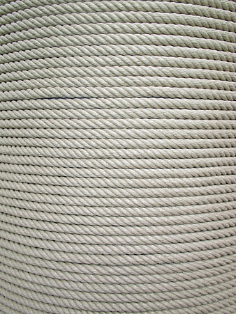 Close-up texture of coiled beige twisted rope