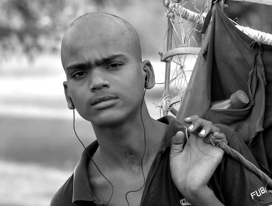 Portrait of young street vendor with earphones